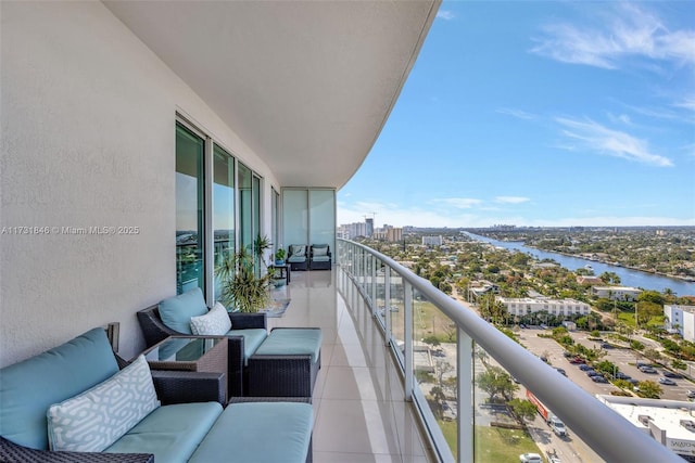 balcony featuring a water view and outdoor lounge area