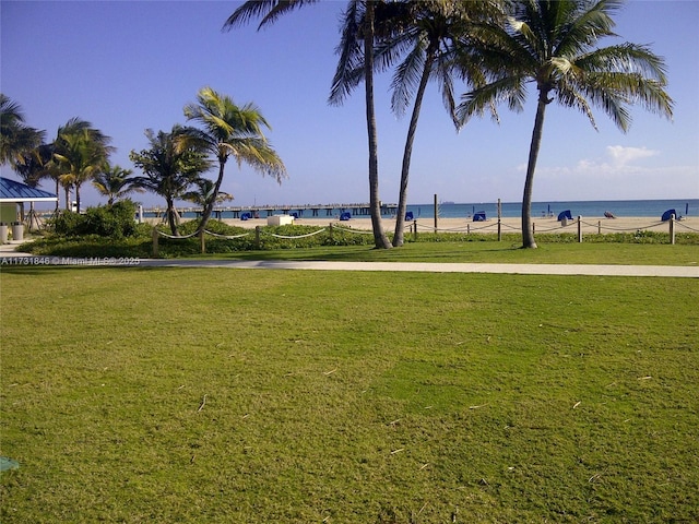 surrounding community featuring a yard and a water view