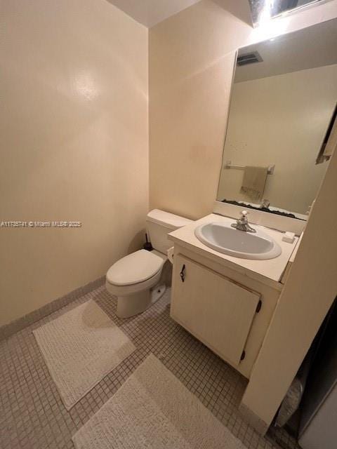 bathroom with vanity, tile patterned floors, and toilet