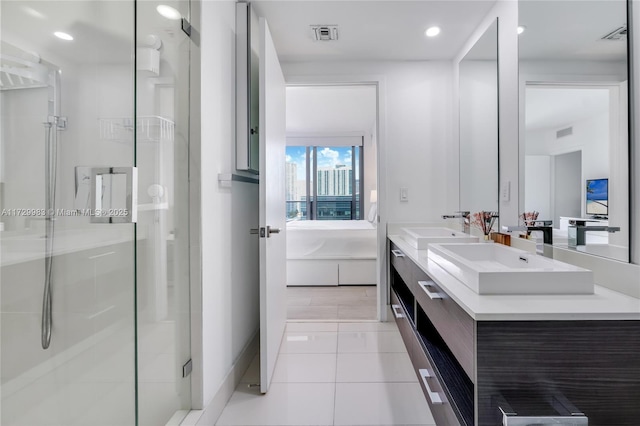 bathroom featuring tile patterned flooring, vanity, and walk in shower