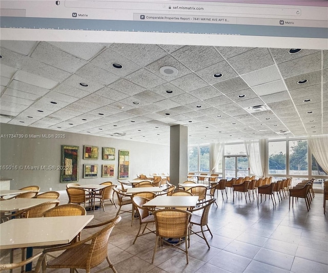 dining area featuring a paneled ceiling