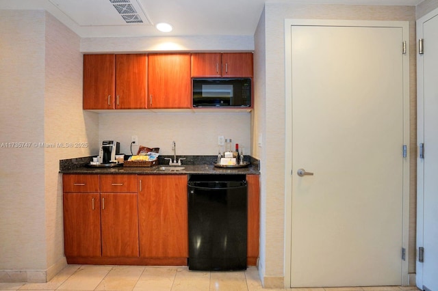 kitchen featuring light tile patterned floors, sink, and black appliances