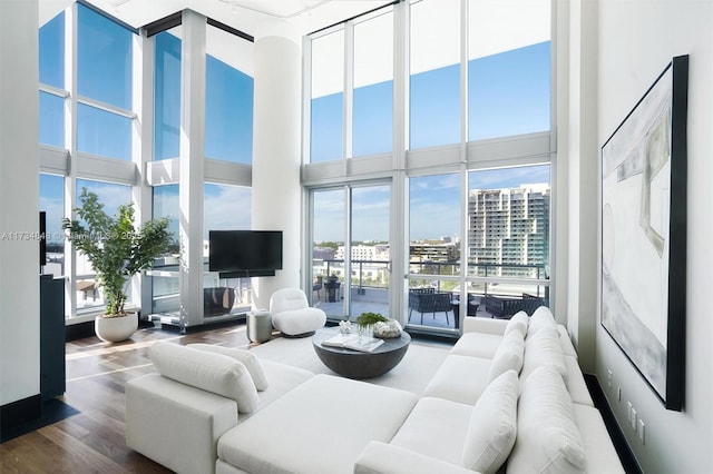 living room featuring wood-type flooring and a high ceiling