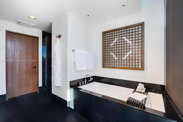 bathroom featuring tiled bath