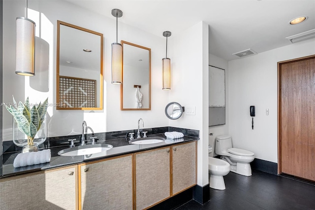 bathroom featuring a bidet, vanity, and toilet