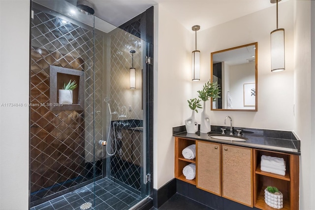 bathroom with vanity and a tile shower