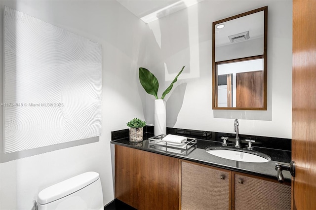 bathroom with vanity and toilet