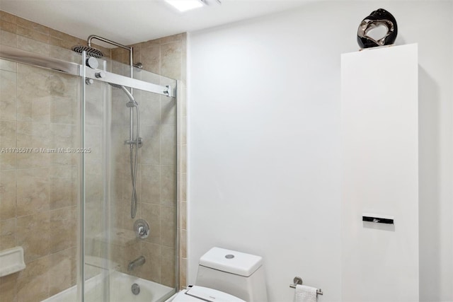 bathroom featuring enclosed tub / shower combo and toilet