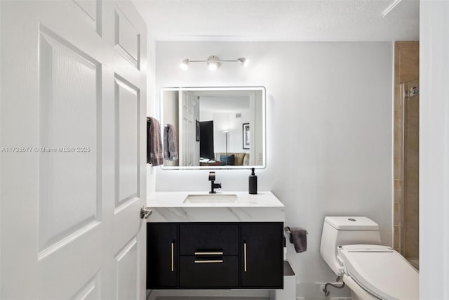 bathroom featuring vanity, a textured ceiling, toilet, and walk in shower