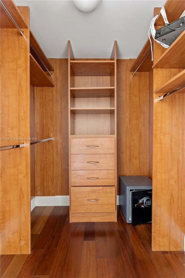 spacious closet with dark hardwood / wood-style floors