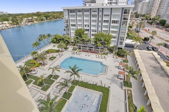 view of pool with a patio and a water view