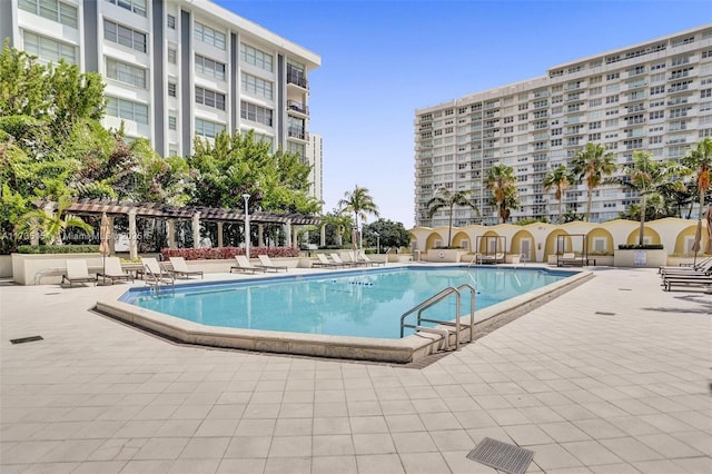 view of pool with a patio and a pergola