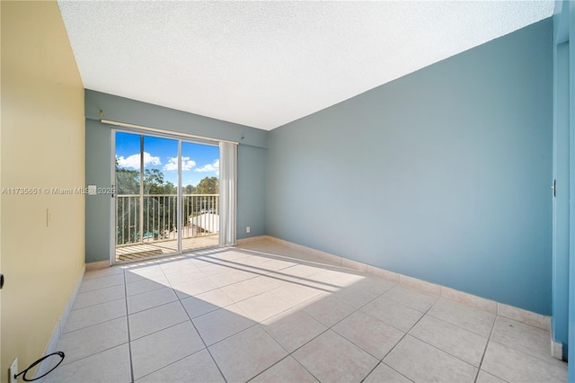 tiled spare room with a textured ceiling