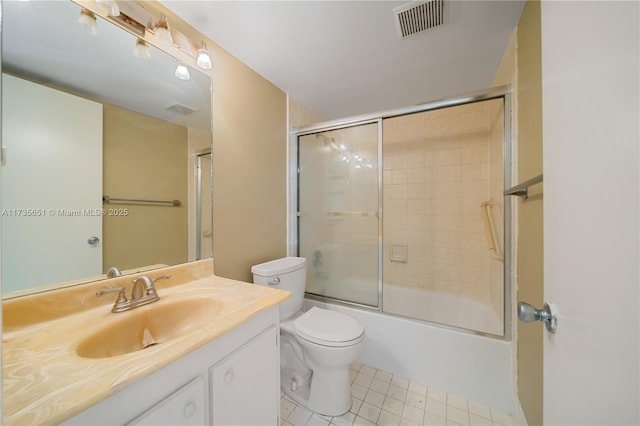 full bathroom with vanity, toilet, tile patterned flooring, and combined bath / shower with glass door