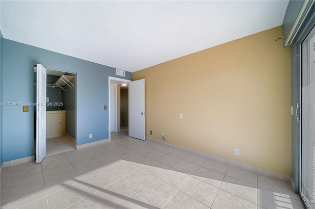 unfurnished bedroom featuring light tile patterned floors