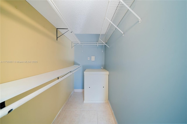 spacious closet featuring light tile patterned flooring