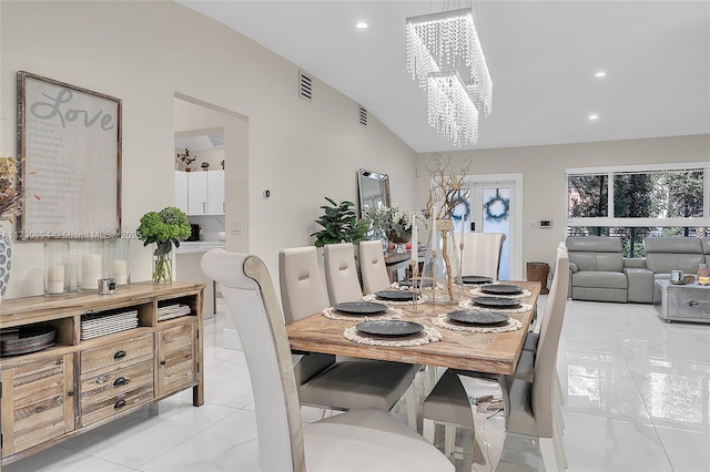 dining area featuring a chandelier and vaulted ceiling