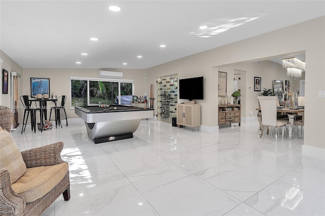 game room featuring an AC wall unit and a notable chandelier