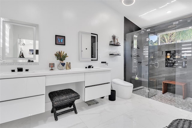 bathroom featuring vanity, toilet, and a shower with door