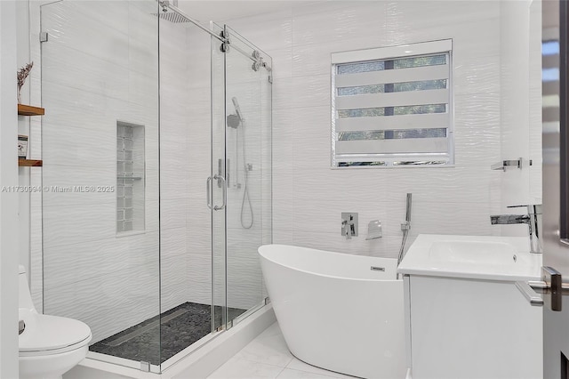 full bathroom with tile walls, vanity, toilet, and separate shower and tub