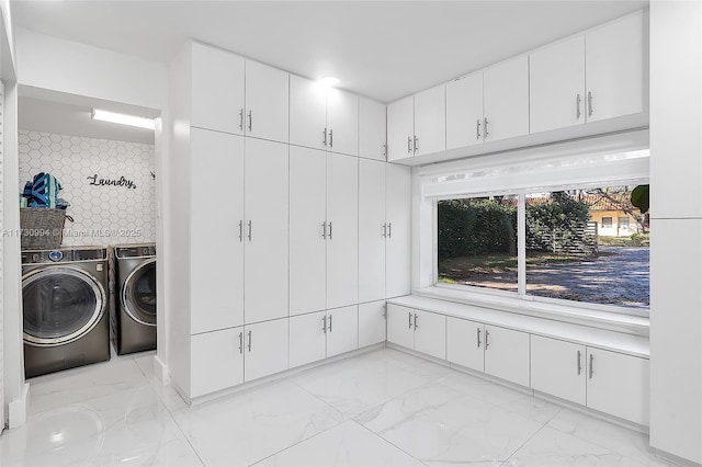 clothes washing area with washer and dryer