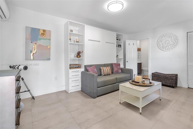 living room with a wall unit AC and baseboards