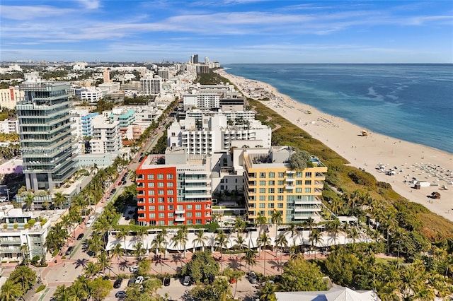 drone / aerial view featuring a water view and a view of the beach