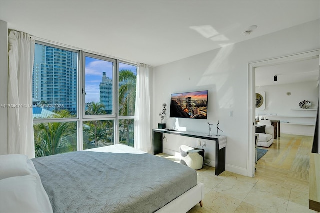 bedroom featuring multiple windows and a wall of windows