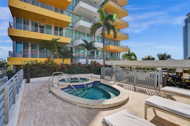 view of swimming pool with a hot tub and a patio