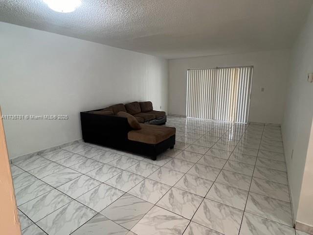 living room with a textured ceiling