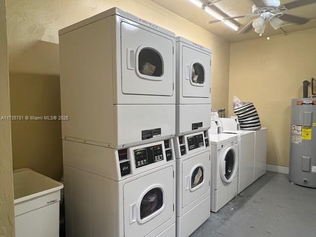 laundry room featuring water heater, washer and dryer, stacked washer / drying machine, and ceiling fan