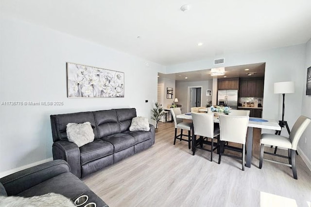 living area featuring recessed lighting, light wood-type flooring, baseboards, and visible vents