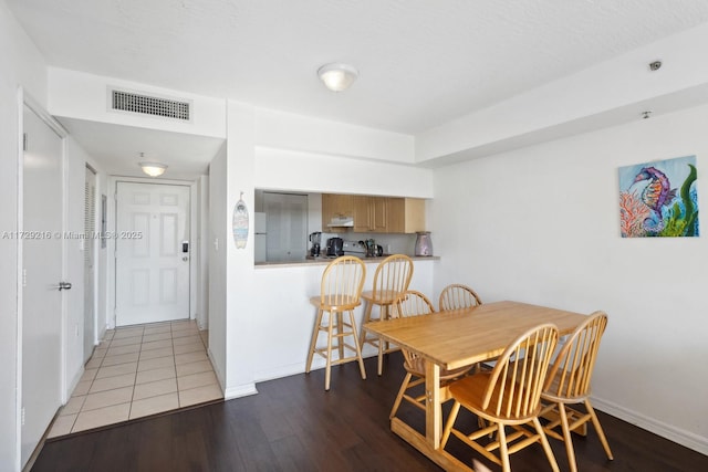 dining area with hardwood / wood-style floors