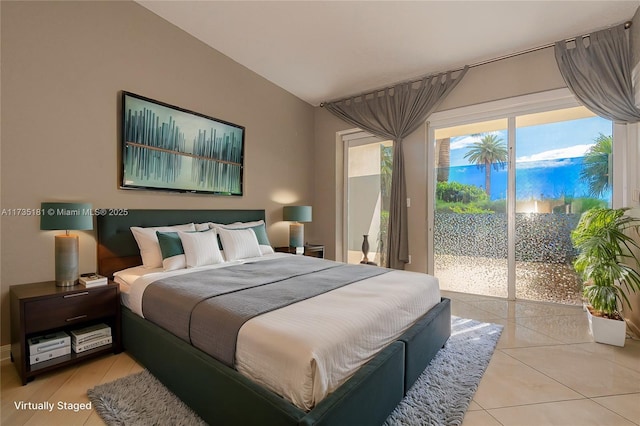 bedroom featuring access to outside, vaulted ceiling, and light tile patterned flooring