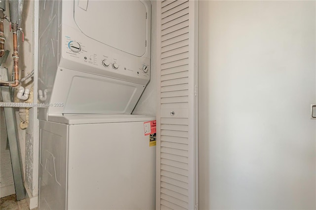 clothes washing area featuring laundry area and stacked washer / dryer