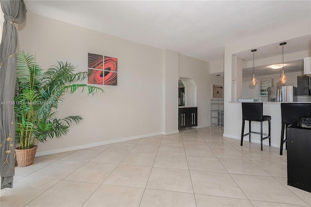 living room with light tile patterned floors and baseboards