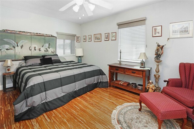 bedroom with hardwood / wood-style flooring and ceiling fan