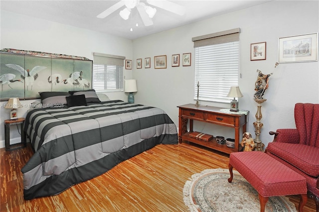 bedroom with a ceiling fan and wood finished floors