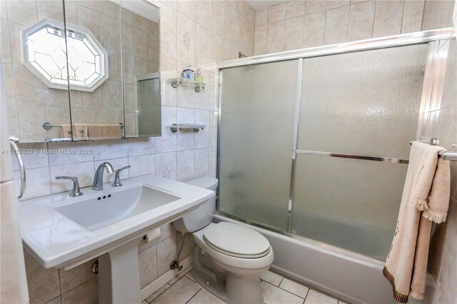 bathroom featuring enclosed tub / shower combo, tile walls, tile patterned flooring, decorative backsplash, and toilet