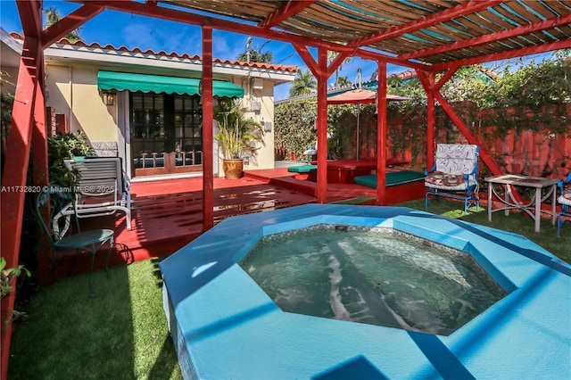 view of pool with fence, an outdoor hot tub, and a pergola