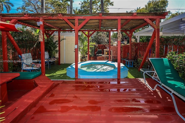 view of patio / terrace with a deck, a pergola, a fenced backyard, and a hot tub