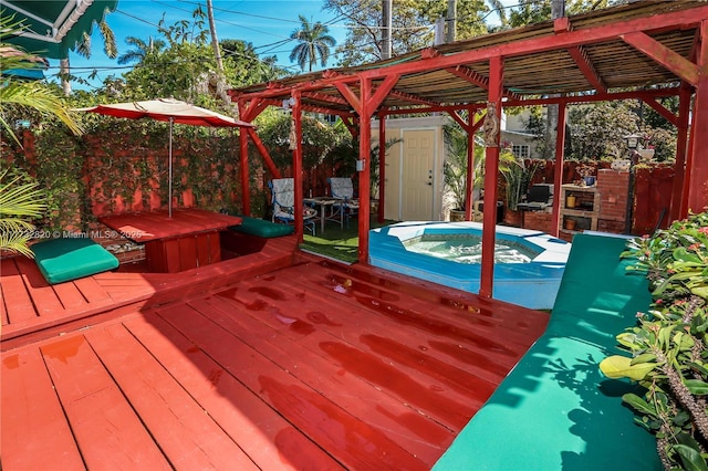 deck with a hot tub and a pergola