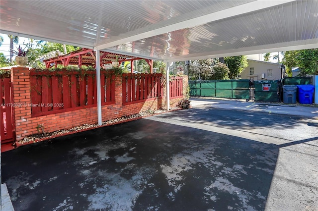 view of patio / terrace with a carport and fence