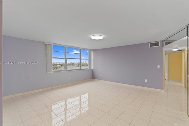 empty room featuring light tile patterned floors