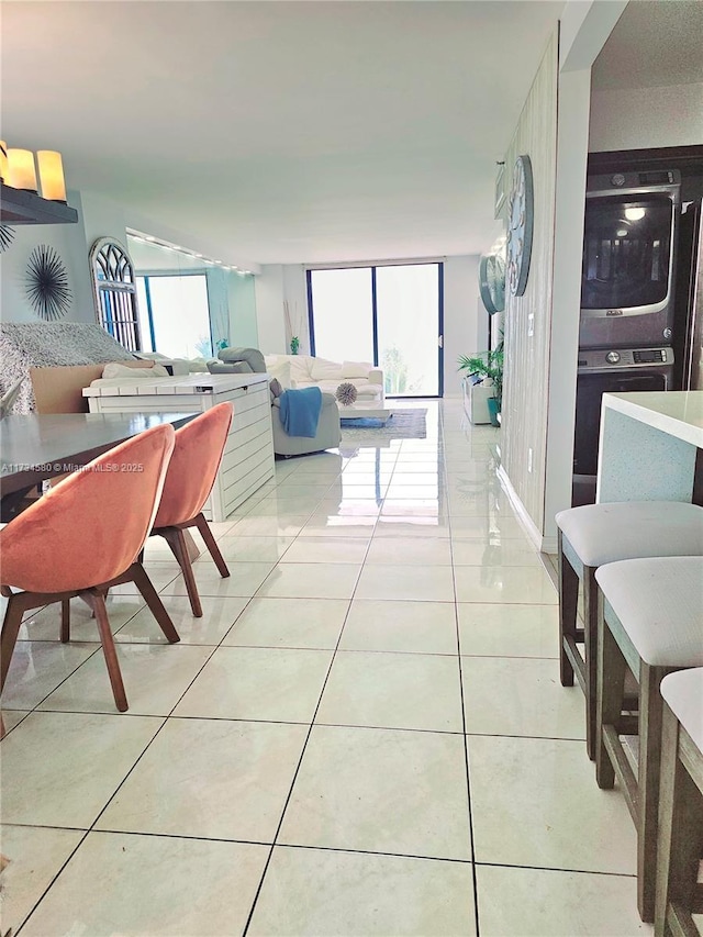 dining space with floor to ceiling windows, a healthy amount of sunlight, and light tile patterned floors