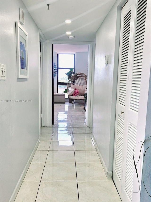 corridor featuring light tile patterned floors