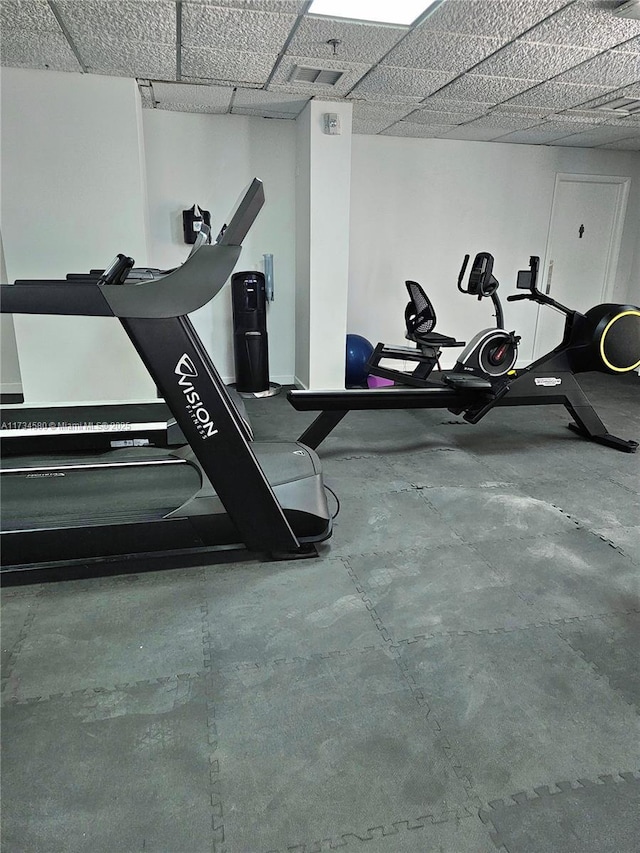 gym with a paneled ceiling