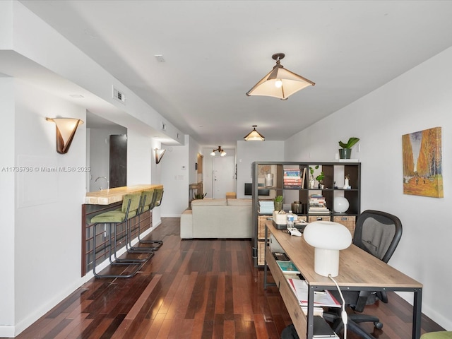 dining area with dark hardwood / wood-style floors