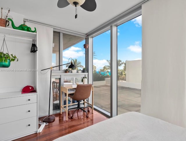 bedroom with hardwood / wood-style flooring and floor to ceiling windows