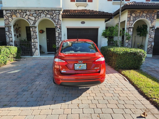 mediterranean / spanish-style home featuring a garage